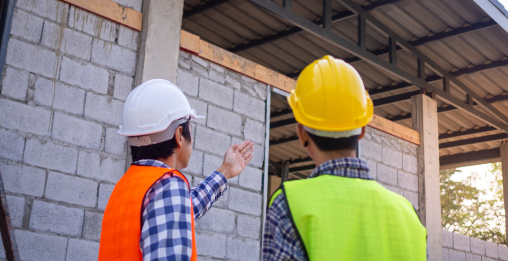 Professional structural engineers conducting on-site assessment of building framework