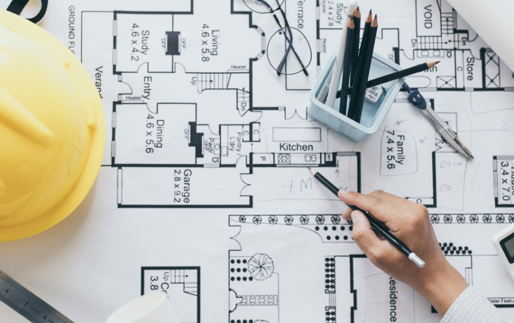 Detailed architectural floor plan with engineering tools and hard hat